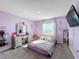 Purple bedroom with a bed, vanity, and window with a view at 583 Taft Dr, Davenport, FL 33837