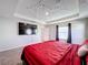Main bedroom with large TV and red bedding at 583 Taft Dr, Davenport, FL 33837