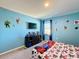 Blue bedroom with Spiderman theme, TV and window at 583 Taft Dr, Davenport, FL 33837