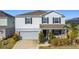 Two-story house with gray siding, stone accents, and a two-car garage at 583 Taft Dr, Davenport, FL 33837
