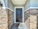 Front entry with a black door and stone veneer at 583 Taft Dr, Davenport, FL 33837