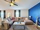 Spacious living room featuring a sectional sofa and large windows at 583 Taft Dr, Davenport, FL 33837