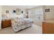 Main bedroom with king bed, nightstand, and window at 7137 Harmony Square Dr # 31A, Harmony, FL 34773