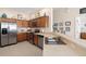 Kitchen with stainless steel appliances and wood cabinets at 7137 Harmony Square Dr # 31A, Harmony, FL 34773