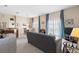 Living room with gray sofa and access to patio at 7137 Harmony Square Dr # 31A, Harmony, FL 34773