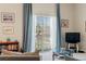 Living room with glass doors leading to balcony at 7137 Harmony Square Dr # 31A, Harmony, FL 34773