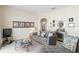 Cozy living room featuring a gray sofa and a glass coffee table at 7137 Harmony Square Dr # 31A, Harmony, FL 34773