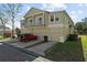 Tan three-story townhouse with balconies and a red Jeep at 7137 Harmony Square Dr # 31A, Harmony, FL 34773