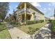 Two-story tan townhouse with front porch and walkway at 7137 Harmony Square Dr # 31A, Harmony, FL 34773