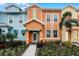 Modern three-story townhouses with colorful exteriors and landscaped yards at 8178 Coconut Pl, Kissimmee, FL 34747