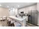 Modern kitchen with white cabinets, island seating, and stainless steel appliances at 8178 Coconut Pl, Kissimmee, FL 34747