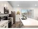 Modern kitchen featuring white cabinets, stainless steel appliances, and a large island at 8178 Coconut Pl, Kissimmee, FL 34747