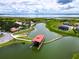 Aerial view of waterfront community with boat dock and lush landscaping at 880 Spinnaker Way, Kissimmee, FL 34746