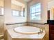 Relax in this luxurious bathroom's corner soaking tub at 880 Spinnaker Way, Kissimmee, FL 34746