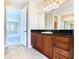 Large bathroom with double vanity and access to bedroom at 880 Spinnaker Way, Kissimmee, FL 34746