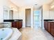 Double vanity bathroom with large soaking tub and separate shower at 880 Spinnaker Way, Kissimmee, FL 34746
