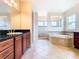 Main bathroom boasts a large soaking tub and walk-in shower at 880 Spinnaker Way, Kissimmee, FL 34746