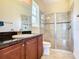 Bathroom boasts granite vanity, shower, and toilet at 880 Spinnaker Way, Kissimmee, FL 34746