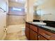 Bathroom includes a bathtub, toilet and granite vanity at 880 Spinnaker Way, Kissimmee, FL 34746