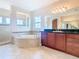 Bathroom features a large soaking tub and double vanity at 880 Spinnaker Way, Kissimmee, FL 34746