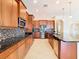 Modern kitchen with stainless steel appliances and dark wood cabinets at 880 Spinnaker Way, Kissimmee, FL 34746