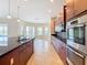 Open concept kitchen with island, stainless steel appliances, and pool view at 880 Spinnaker Way, Kissimmee, FL 34746