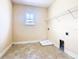 Laundry room with tile flooring and built in shelving at 880 Spinnaker Way, Kissimmee, FL 34746