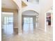Spacious living room with tile floors and views of pool and patio at 880 Spinnaker Way, Kissimmee, FL 34746