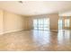 Spacious living area with tile floors and sliding doors leading to the pool at 880 Spinnaker Way, Kissimmee, FL 34746