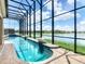 Enclosed pool and spa with lake view at 880 Spinnaker Way, Kissimmee, FL 34746