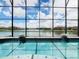 Enclosed pool and spa with a lake view at 880 Spinnaker Way, Kissimmee, FL 34746