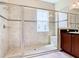 Large walk-in shower with built-in seat and tile surround at 880 Spinnaker Way, Kissimmee, FL 34746