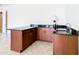 Wet bar with granite countertop and wood cabinets at 880 Spinnaker Way, Kissimmee, FL 34746