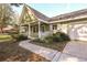 Front view of a green house with white porch at 8863 Sw 92Nd Ln # A, Ocala, FL 34481