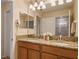Double vanity with granite countertop and large mirror at 8963 Coco Palm Rd, Kissimmee, FL 34747