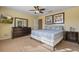 Striped bedding, dresser, and large mirror in a comfortable bedroom at 8963 Coco Palm Rd, Kissimmee, FL 34747