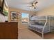 Bunk beds, dresser, TV, and ceiling fan in this ' bedroom at 8963 Coco Palm Rd, Kissimmee, FL 34747