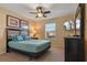 Bedroom with a queen-size bed, dresser, and ceiling fan at 8963 Coco Palm Rd, Kissimmee, FL 34747