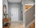 Bright and airy foyer with tile flooring, a wooden console table, and stairway at 8963 Coco Palm Rd, Kissimmee, FL 34747