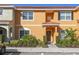 Inviting exterior of two-story townhome with landscaping and a welcoming entrance at 8963 Coco Palm Rd, Kissimmee, FL 34747