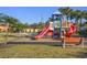 playground with slides and a bench at 8963 Coco Palm Rd, Kissimmee, FL 34747