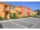 Exterior view of colorful townhomes with parking at 8963 Coco Palm Rd, Kissimmee, FL 34747