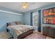 Cozy bedroom with light blue walls, a double bed, and a ceiling fan at 102 Circle Hill Rd, Sanford, FL 32773