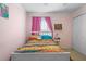 Bright bedroom featuring a full-size bed, pink curtains, and closet at 102 Circle Hill Rd, Sanford, FL 32773