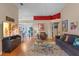 Bright living room with hardwood floors, comfy seating, and a view into the kitchen at 102 Circle Hill Rd, Sanford, FL 32773