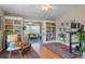 Living room with hardwood floors, built-in shelves, and sunroom access at 102 Circle Hill Rd, Sanford, FL 32773
