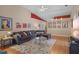 Open living room with hardwood floors, sectional sofa and gallery wall at 102 Circle Hill Rd, Sanford, FL 32773