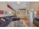 Bright living room with hardwood floors, sectional sofa, and access to kitchen at 102 Circle Hill Rd, Sanford, FL 32773