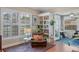 Living room with hardwood floors, built-in shelves, and sunroom access at 102 Circle Hill Rd, Sanford, FL 32773