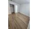Bright bedroom with wood-look floors, a closet, and an ensuite bathroom at 10232 Turkey Lake Rd # 181, Orlando, FL 32819